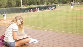 Studying at the baseball field offers entertainment and fresh air.  (photo: Breanne Bizette )