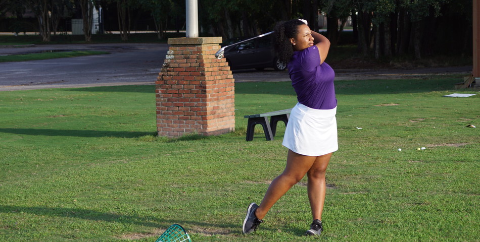 : Lauryn Herman practices at the SHC driving range.