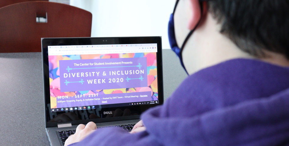BessMorgan Bayulut: Student looks at Diversity & Inclusion Week flyer.