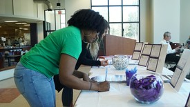 Students sign up at the Give Day table in the cafeteria.  (photo: )