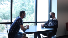 Benedikt Kraemling and Fabian Keiblinger chat in the Student Center. (photo: Bessmorgan Baluyut)