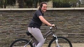 Sophomore Betsy Blumenfeld rides the bicycle she won in the raffle. (photo: Caroline Weishaar)
