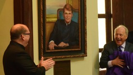 SHC President Dr. Christopher Puto, right, and Fr. Mark Mossa, S.J., at left, react at the unveiling of a portrait of the Rev. William J. Rewak S.J. The unveiling celebrated the naming of the Rotunda in honor of Rev. Rewak. (photo: Samm Brown)